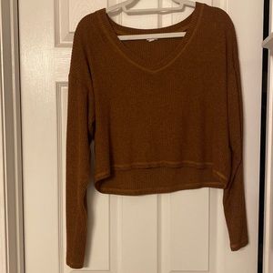 Burnt orange long-sleeved blouse.